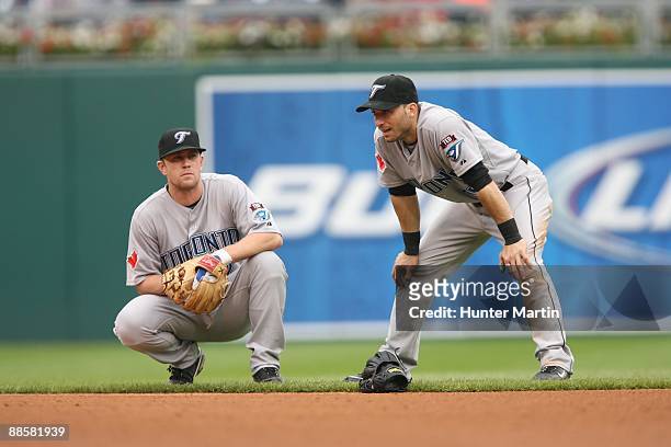 Second baseman Aaron Hill and shortstop Marco Scutaro of the Toronto Blue Jays take a break during a pitching change during a game against the...