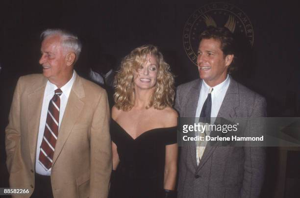 American acting couple Farrah Fawcett and Ryan O'Neal pose with Fawcett's father, James Fawcett, at the Cineplex Odeon Universal Cinema at the...