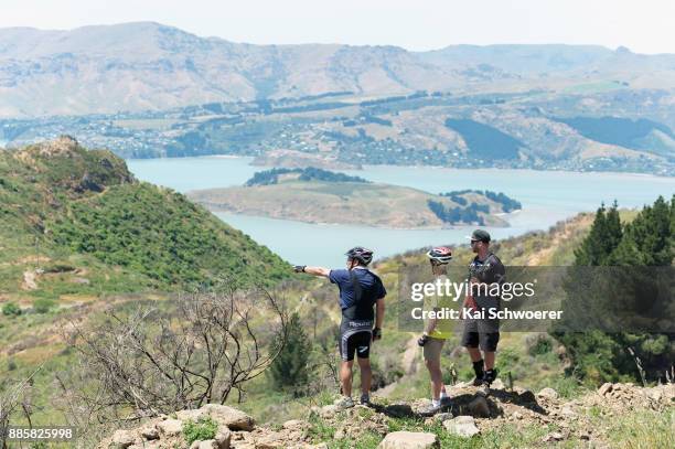 Mountain bikers take a look at the burned forest at Christchurch Adventure Park on December 5, 2017 in Christchurch, New Zealand. The park was closed...