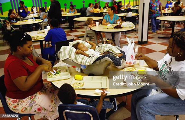 Homeless six-month-old baby Maleya Nevills sleeps while her family eats dinner at the Family Gateway homeless shelter on June 18, 2009 in Dallas,...