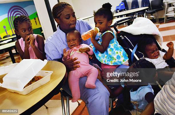 Jennifer Ross, living in a homeless shelter with her five children, sits in the shelter dining hall after dinner on June 18, 2009 in Dallas, Texas....
