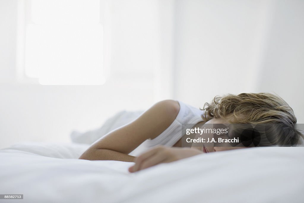 Boy sleeping on bed