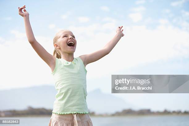 girl with arms raised shouting at sky - girl open mouth bildbanksfoton och bilder