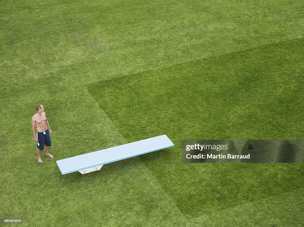 Swimmer and diving board in grass