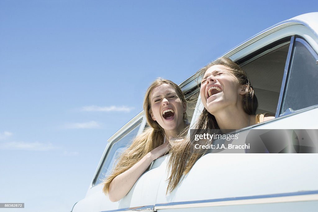 Friends shouting out car window