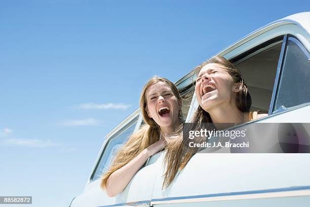 friends shouting out car window - blue car stock pictures, royalty-free photos & images