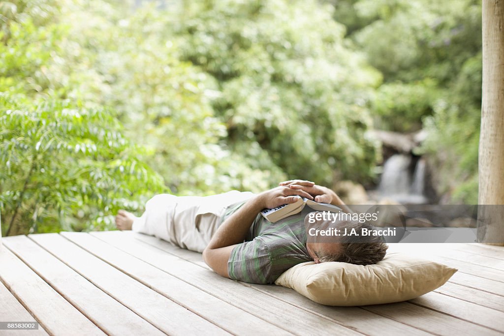 Man napping on porch in remote area