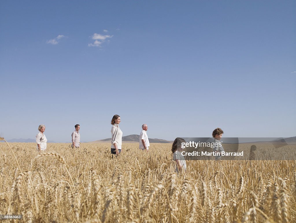 People standing in remote wheat field