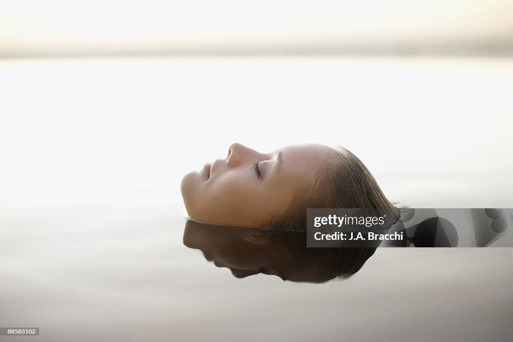 Woman soaking in swimming pool