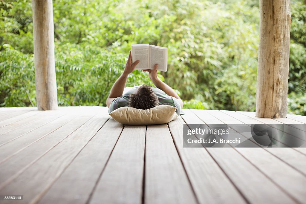 Man reading on porch in remote area