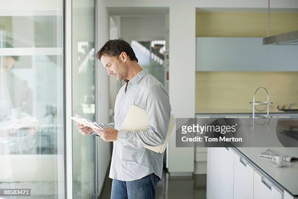 man sorting mail at home - reading mail stock pictures, royalty-free photos & images