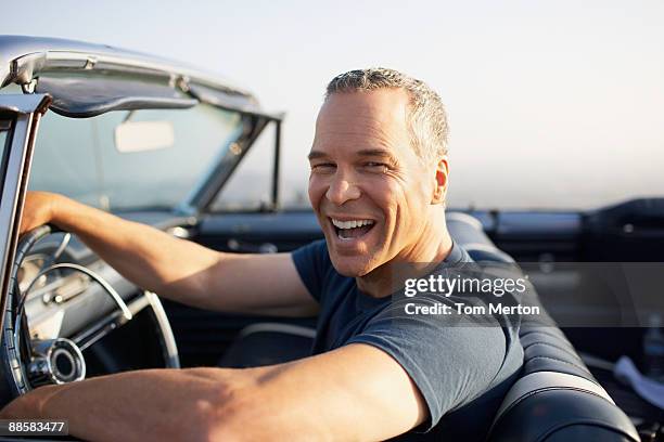 man driving convertible car - classic cars stock pictures, royalty-free photos & images