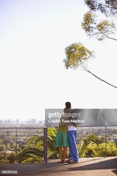 couple enjoying view from balcony - looking over balcony stock pictures, royalty-free photos & images