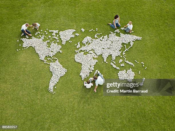 parents and children making world map made of rocks - green belt fashion item stock pictures, royalty-free photos & images