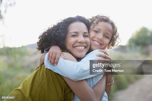 mother and son hugging outdoors - pacific islander stock pictures, royalty-free photos & images