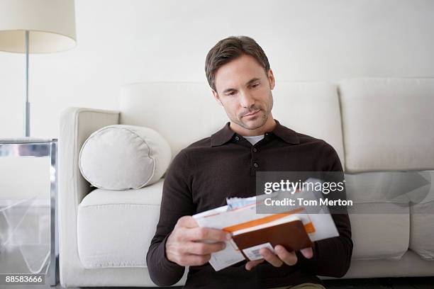 man sorting bills at home - post structure stock pictures, royalty-free photos & images