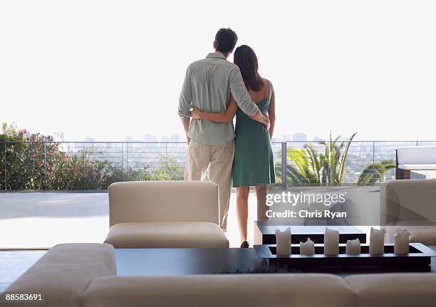 couple enjoying view from balcony - balcony stock pictures, royalty-free photos & images