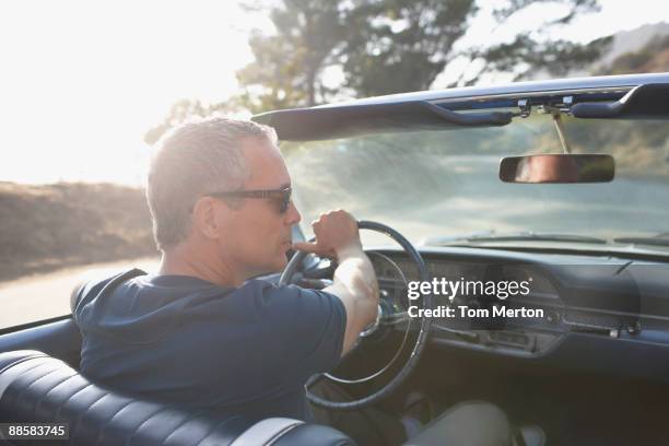 man driving classic convertible car - classic car stock pictures, royalty-free photos & images