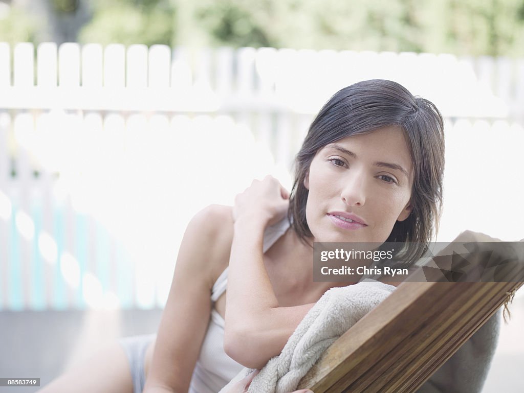 Portrait of woman sitting in patio chair