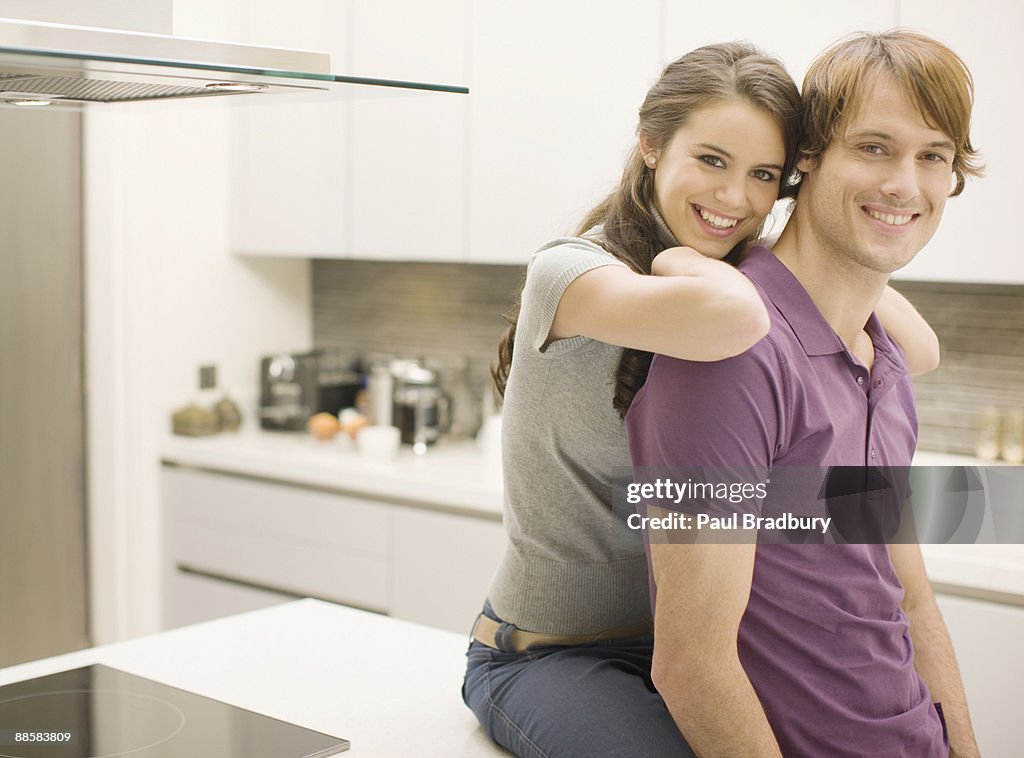 Couple posing in kitchen