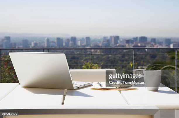 laptop and paperwork on balcony table - coffee on patio stock pictures, royalty-free photos & images