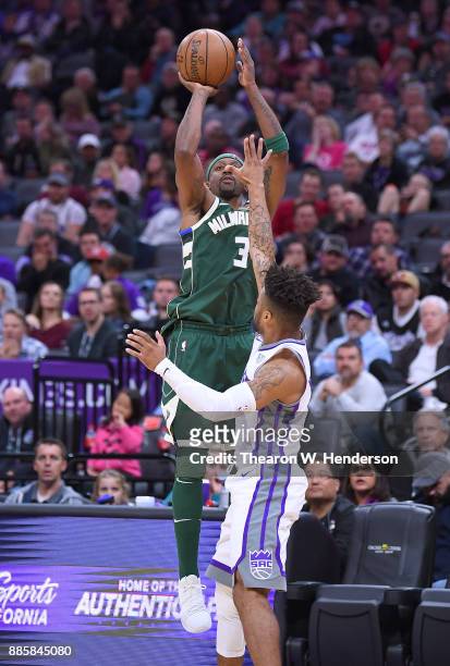 Jason Terry of the Milwaukee Bucks shoots over Frank Mason III of the Sacramento Kings during their NBA basketball game at Golden 1 Center on...