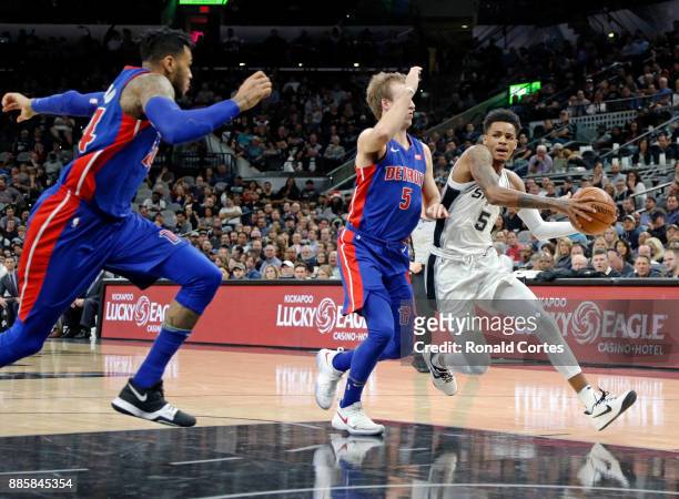 Dejounte Murray of the San Antonio Spurs tries to drive past Luke Kennard of the Detroit Pistons at AT&T Center on December 04, 2017 in San Antonio,...