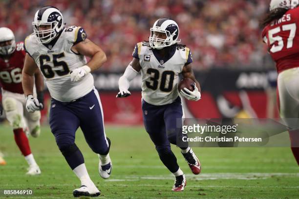 Running back Todd Gurley of the Los Angeles Rams ruhses the football alongside center John Sullivan during the NFL game against the Arizona Cardinals...
