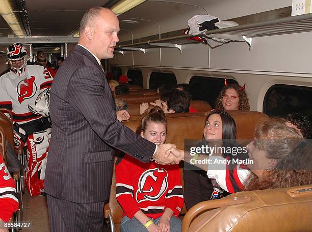 Former New Jersey Devils defenseman Ken Daneyko greets a fan on the train to Trenton prior to seeing Martin Brodeur honored by the State of New...