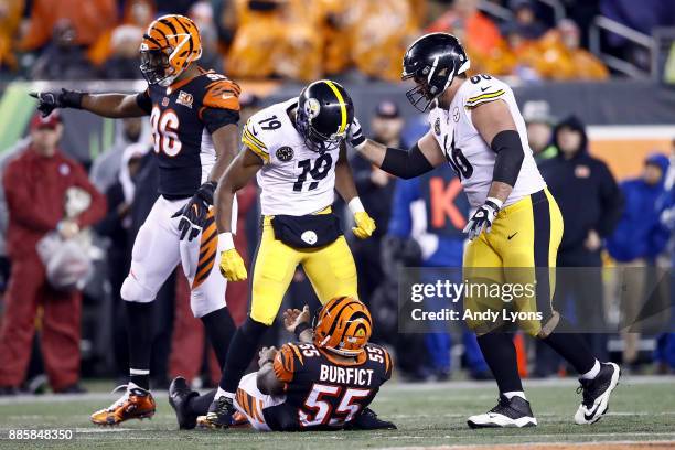 JuJu Smith-Schuster of the Pittsburgh Steelers stands over Vontaze Burfict of the Cincinnati Bengals after a hit during the second half at Paul Brown...