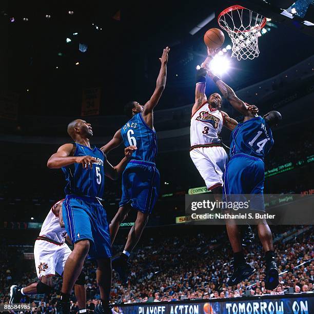 Allen Iverson of the Philadelphia 76ers shoots a layup against Anthony Mason, Eddie Jones and Elden Campbell of the Charlotte Hornets in Game Three...