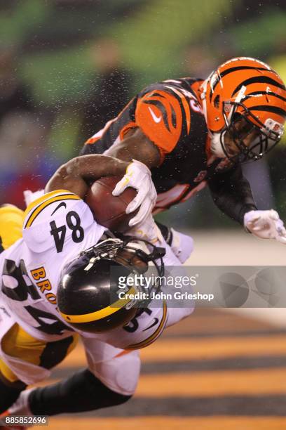 Antonio Brown of the Pittsburgh Steelers catches a touchdown pass as he is hit by George Iloka of the Cincinnati Bengals during the second half at...