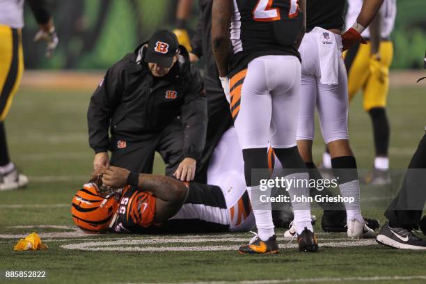 Vontaze Burfict of the Cincinnati Bengals is attended to by trainers after a unsportsmanlike penalty against the Pittsburgh Steelers during the...