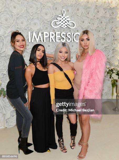 Desi Perkins, Nida, Isabel Bedoya, and Melly Sanchez pose with fan at Impressions Vanity Melrose Grand Opening Gala on December 4, 2017 in Los...