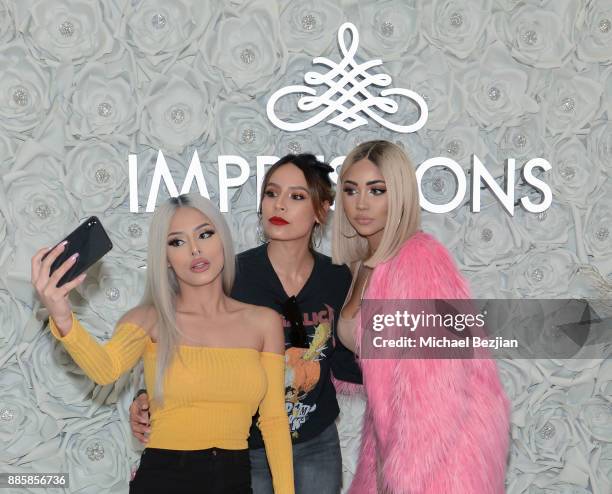 Isabel Bedoya, Desi Perkins, and Melly Sanchez attend Impressions Vanity Melrose Grand Opening Gala on December 4, 2017 in Los Angeles, California.