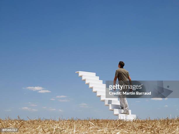 man ascending stairway to sky - 階段　のぼる ストックフォトと画像