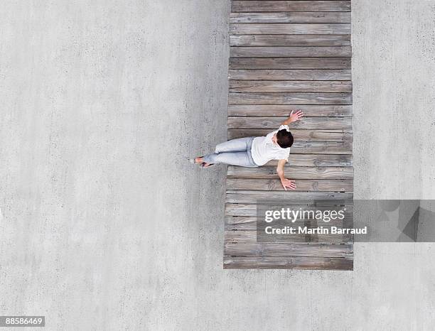 woman sitting on wooden dock - pier 1 stock pictures, royalty-free photos & images