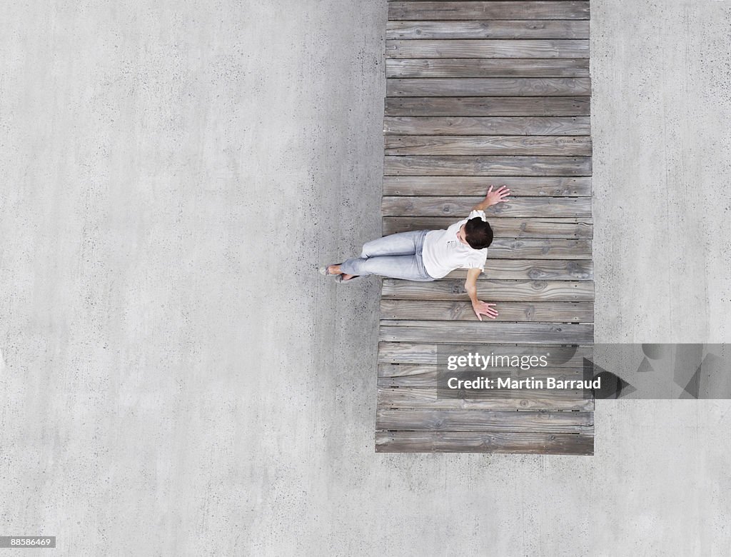Woman sitting on wooden dock
