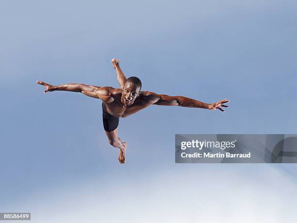 man jumping - man arms outstretched stock pictures, royalty-free photos & images