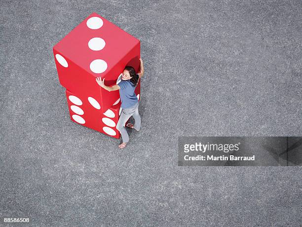 woman stacking pair of giant dice - big hug stock pictures, royalty-free photos & images