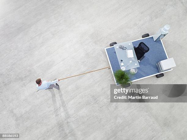 businessman pulling portable office - bureau de change stockfoto's en -beelden