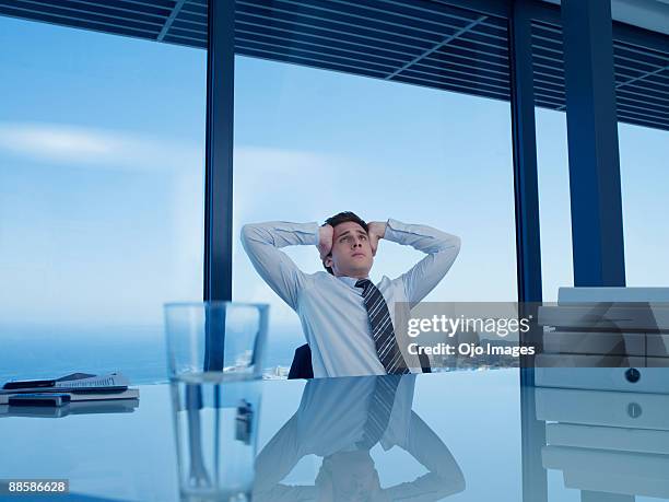 stressed businessman in office - overdoing stock pictures, royalty-free photos & images