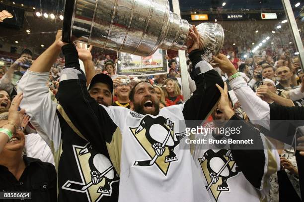 Maxime Talbot of the Pittsburgh Penguins holds the Stanley Cup following the Penguins victory over the Detroit Red Wings in Game Seven of the 2009...