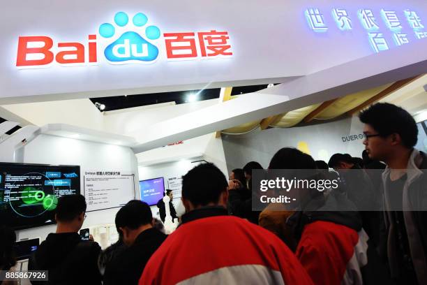 This photo taken on December 4, 2017 shows people visiting the Baidu booth during the 4th World Internet Conference in Wuzhen in China's eastern...