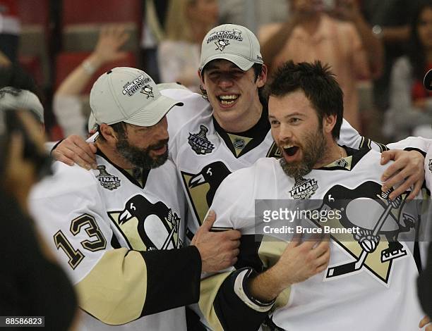 Bill Guerin, Evgeni Malkin and Petr Sykora of the Pittsburgh Penguins celebrate following the Penguins victory over the Detroit Red Wings in Game...