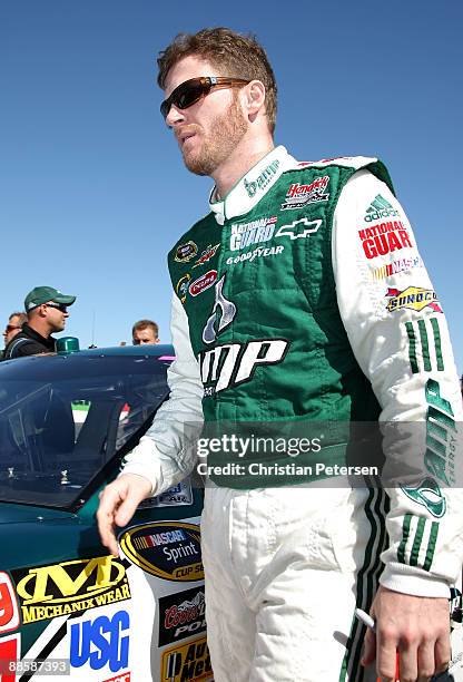 Dale Earnhardt Jr, driver of the AMP Energy/National Guard/Mountain Dew Chevrolet, walks on the grid during qualifying for the NASCAR Sprint Cup...