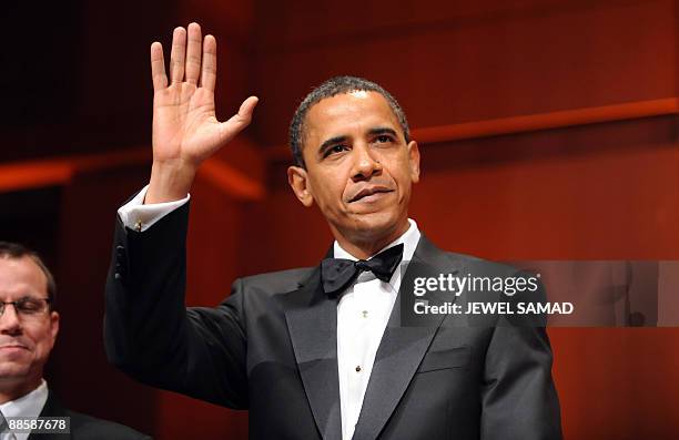 President Barack Obama waves as he arrives at the Radio and Television Correspondents Association Dinner at the Walter E. Washington Convention...