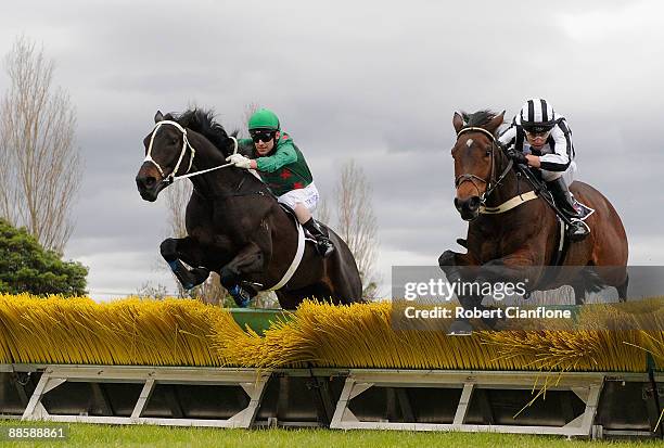 Adam Trinder riding Periomen and Brett Scott riding Destiny Calls jump the final hurdle during race two the Ted Best Hurdle at Moone Valley Racing...