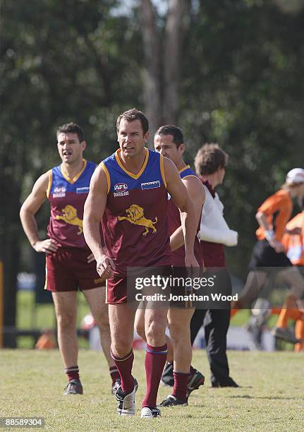 Wayne Carey of the Lions warms up prior to the QAFL Pineapple Hotel Cup Division Two match between the Palm Beach-Currumbin Lions and the...