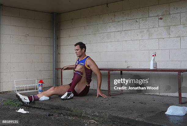 Wayne Carey of the Lions ices his leg after leaving the field of play injured during the QAFL Pineapple Hotel Cup Division Two match between the Palm...